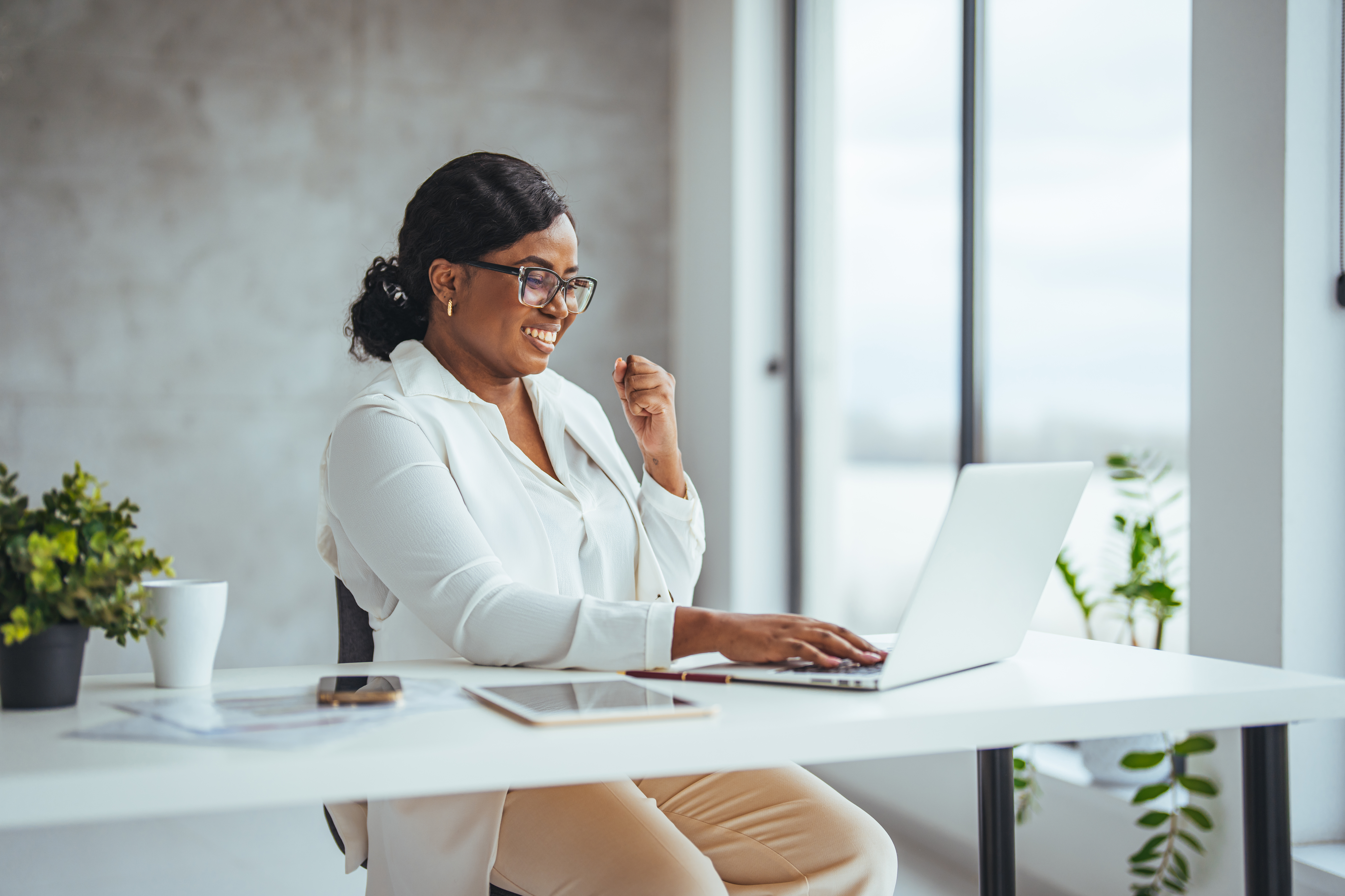 Photo: founder in white blazer at her desk