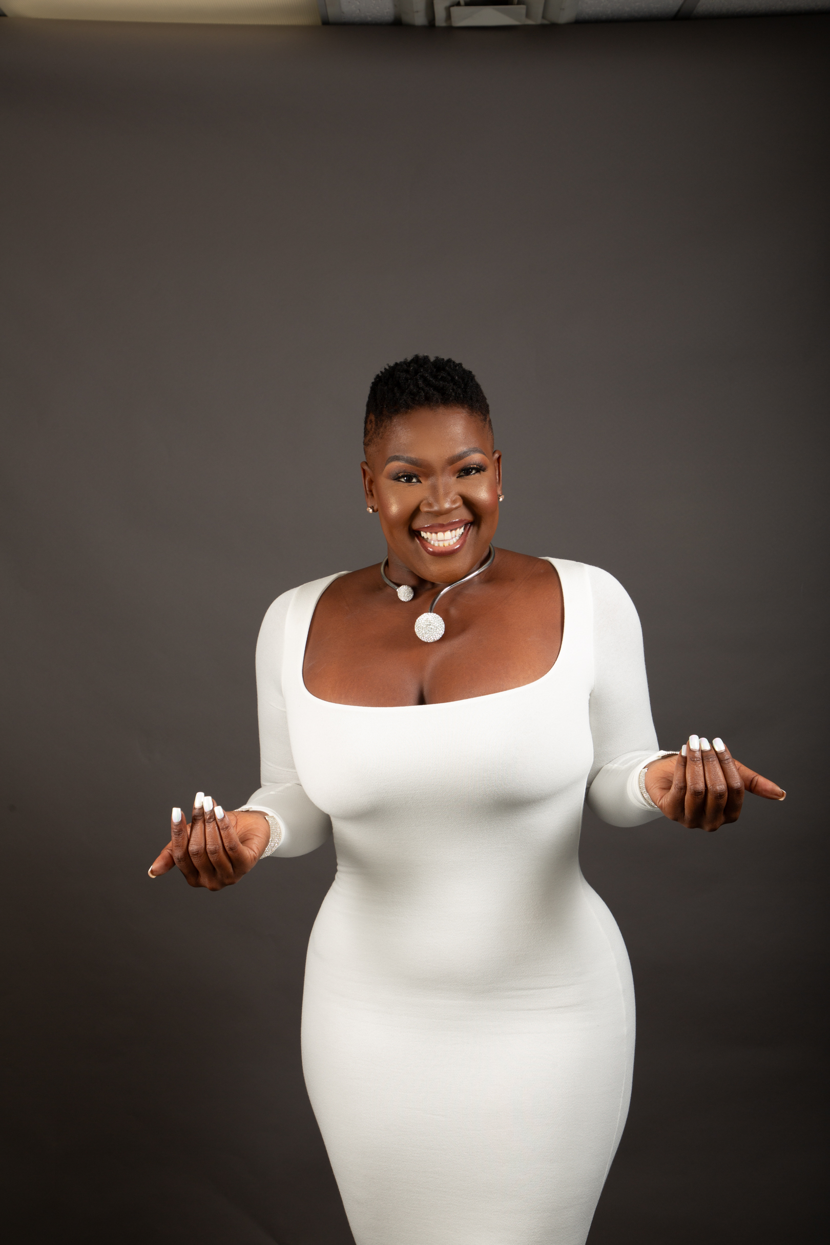 Photo: Dee in white dress pointing, your AI product is waiting
